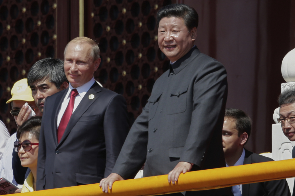 FILE - Chinese President Xi Jinping, right, and Russian President Vladimir Putin observe a parade commemorating the 70th anniversary of Japan's World War II defeat, from Tiananmen Gate in Beijing, on Sept. 3, 2015. (AP Photo/Ng Han Guan, File)