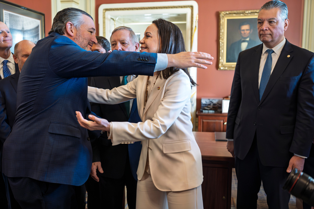 Venezuelan opposition leader Maria Corina Machado reaches out to embrace Sen. Ted Cruz, R-Texas, left, as the Nobel Peace Prize recipient meets with Sen. Alex Padilla, D-Calif., right, and others two weeks after President Donald Trump toppled Venezuelan president Nicolas Maduro in a stunning military raid, at the Capitol in Washington, Thursday, Jan. 15, 2026. (AP Photo/J. Scott Applewhite)