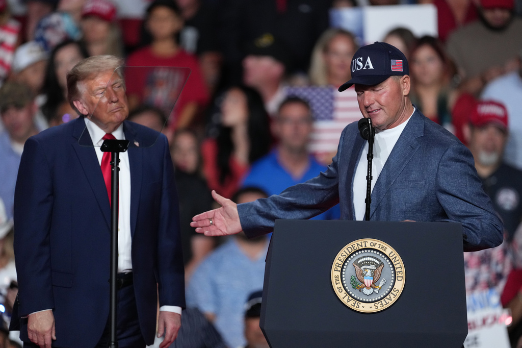 President Donald Trump listens as Roger Clemens speaks at a campaign rally at the Freeman Coliseum in San Antonio, Wednesday, Oct. 7, 2026. (AP Photo/Eric Gay)