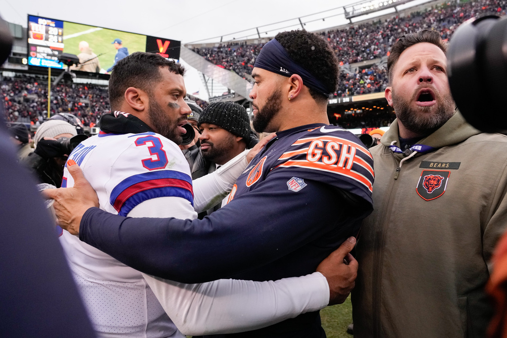 New York Giants quarterback Russell Wilson (3) greets Chicago Bears quarterback Caleb Williams (18) after an NFL football game Sunday, Nov. 9, 2025, in Chicago. (AP Photo/Nam Y. Huh)