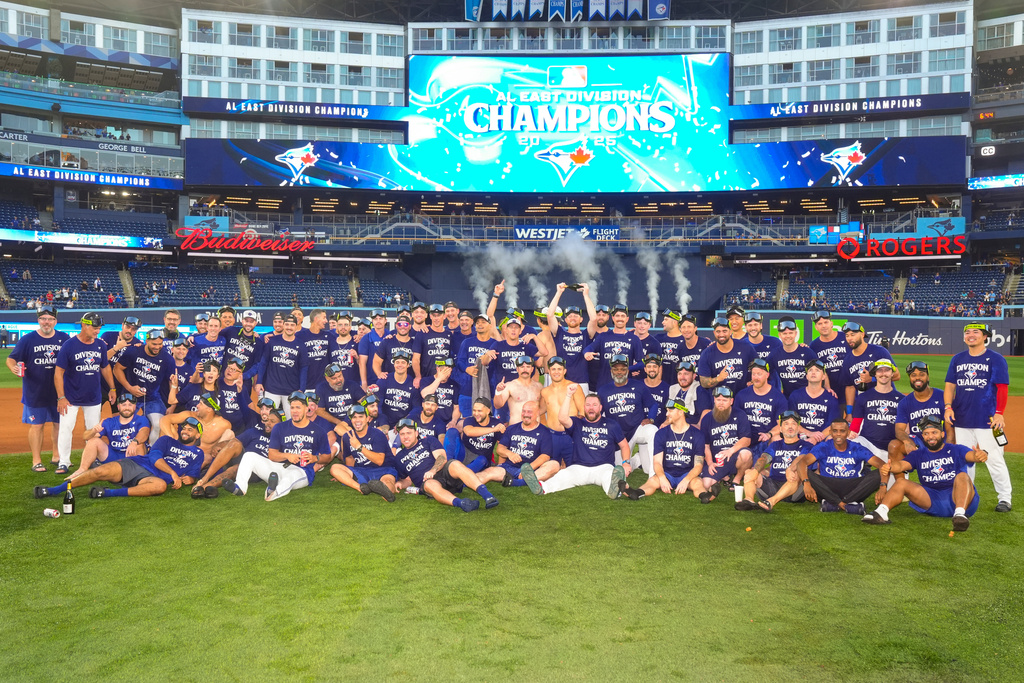 Toronto Blue Jays celebrate after winning the American League East Division title following MLB baseball action against the Tampa Bay Rays, in Toronto, Sunday, Sept. 28, 2025. (Chris Young/The Canadian Press via AP)