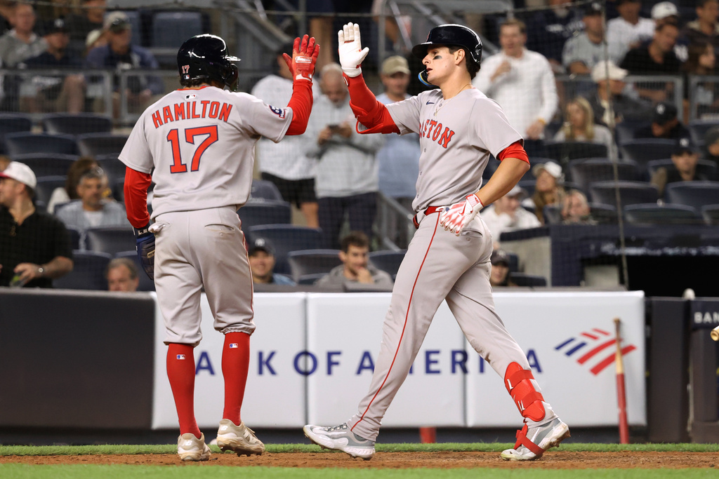 Boston Red Sox's David Hamilton, left, and Roman Anthony, right, react after Anthony hit a two-run home run during the ninth inning of a baseball game against the New York Yankees, Thursday, Aug. 21, 2025, in New York. (AP Photo/Pamela Smith)