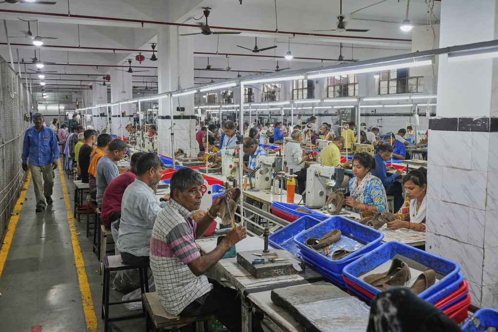 Workers in a manufacturing unit make leather footwear in Agra, India, Monday, Aug. 25, 2025. (AP Photo/Manish Swarup)