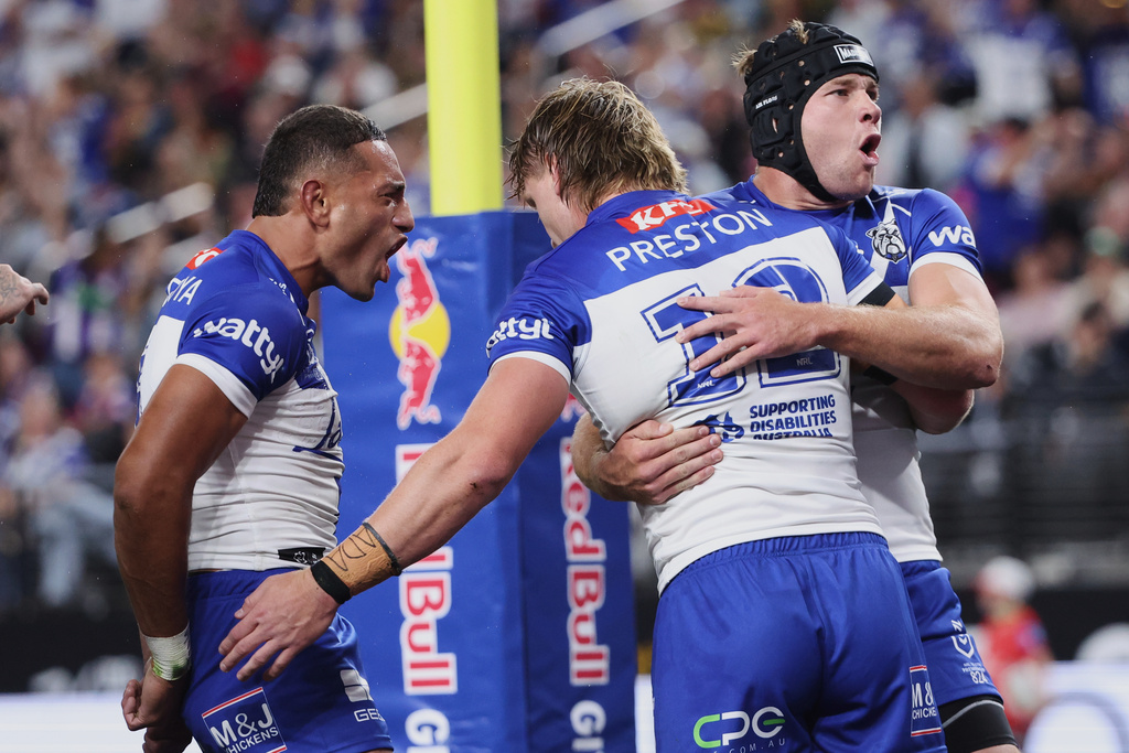 Bulldogs Jacob Preston, center, is congratulated by teammates after scoring a try during the Australia National Rugby League game between the Canterbury Bulldogs and the St George-Illawarra Dragons in Las Vegas, Saturday, Feb. 28, 2026. (AP Photo/Ian Maule)