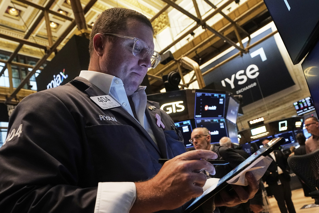 Trader Ryan Falvey works on the floor of the New York Stock Exchange, Thursday, Aug. 14, 2025. (AP Photo/Richard Drew)