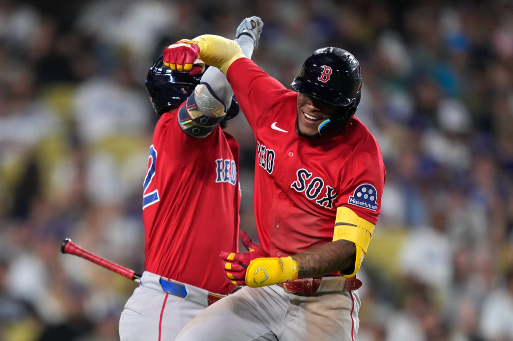 Boston Red Sox's Ceddanne Rafaela, right, celebrates with Wilyer Abreu after hitting a two-run home run during the seventh inning of a baseball game against the Los Angeles Dodgers, Friday, July 31, 2026, in Los Angeles. (AP Photo/Mark J. Terrill)