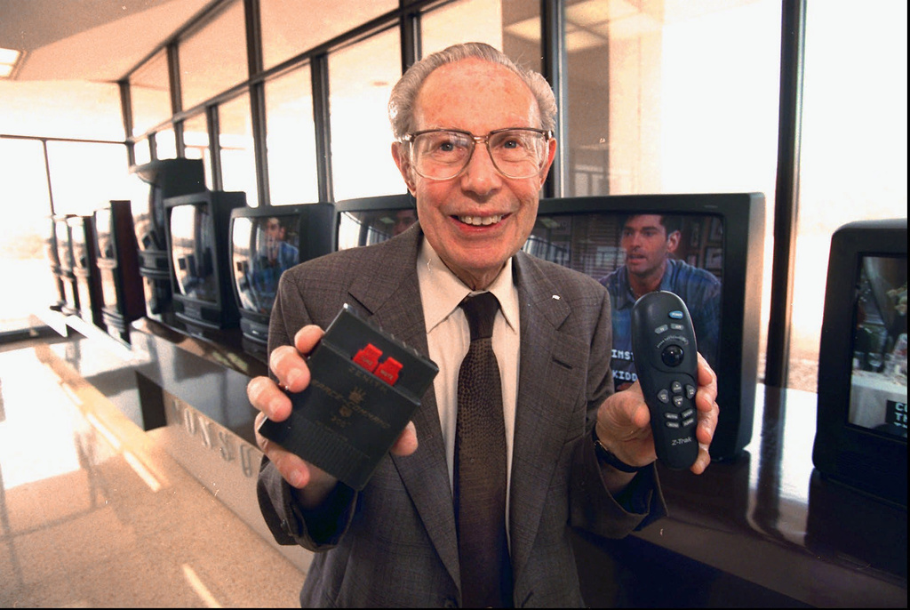 FILE - Robert Adler, co-inventor of the TV remote, poses with remotes at Zenith in Glenview, Ill., March 28, 1996. (AP Photo/Chicago Sun-Times, Al Podgorski, File)