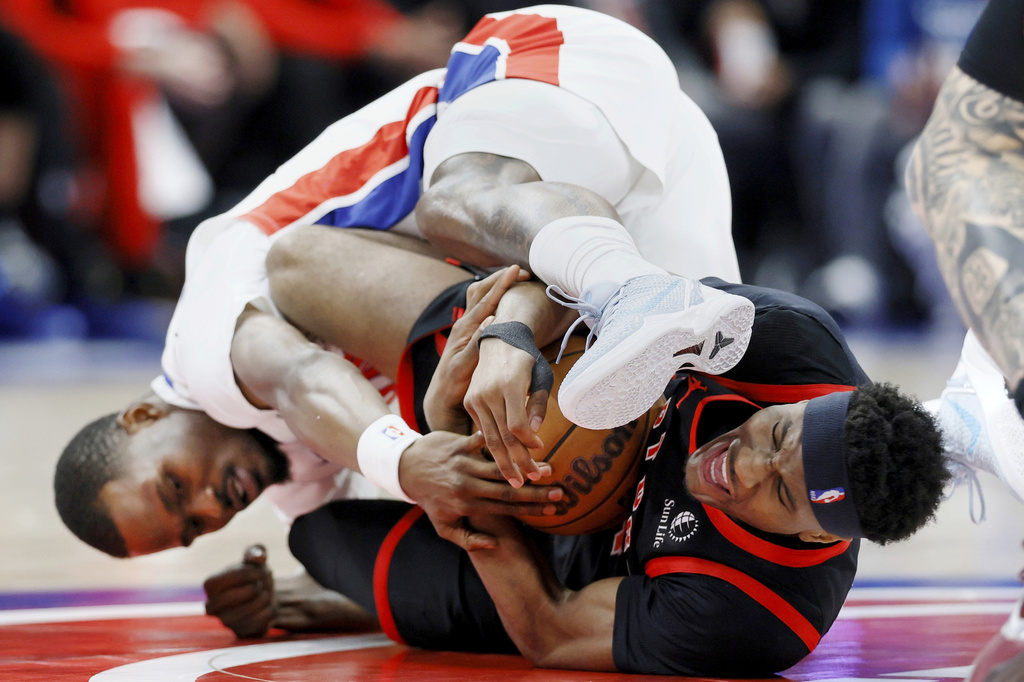 Toronto Raptors guard Ja'kobe Walter, right, and Detroit Pistons guard Javonte Green fight over a loose ball during the first half of an NBA basketball game Tuesday, March 31, 2026, in Detroit. (AP Photo/Duane Burleson)