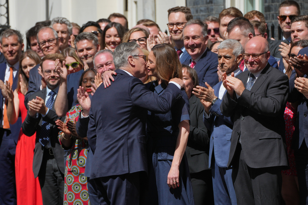 Britain's outgoing Prime Minister Keir Starmer and wife Victoria hug as they leave 10 Downing Street in London, Monday, July 20, 2026.(AP Photo/Kin Cheung)