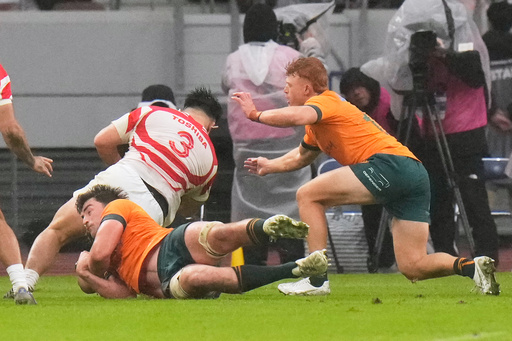 Japan's Shuhei Takeuchi runs through the tackle of Australia's Jeremy Williams and Tame Edmed, right, to score a try during a rugby test between the Wallabies and Japan in Tokyo, Saturday, Oct. 25, 2025. (AP Photo/Shuji Kajiyama) Japan's Shuhei Takeuchi runs through the tackle of Australia's Jeremy Williams and Tame Edmed, right, to score a try during a rugby test between the Wallabies and Japan in Tokyo, Saturday, Oct. 25, 2025. (AP Photo/Shuji Kajiyama)