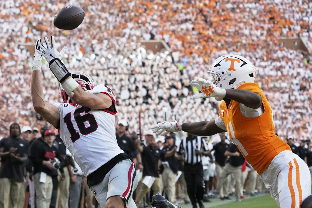 Georgia wide receiver London Humphreys (16) catches a touchdown pass over Tennessee defensive back Ty Redmond (4) during the second half of an NCAA college football game Saturday, Sept. 13, 2025, in Knoxville, Tenn. (AP Photo/George Walker IV)
