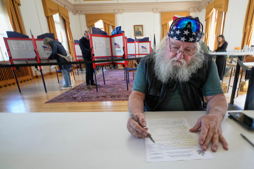 Jim McDonald fills out a form for early voting, Tuesday, Oct. 28, 2025, in Portland, Maine. (AP Photo/Robert F. Bukaty) Jim McDonald fills out a form for early voting, Tuesday, Oct. 28, 2025, in Portland, Maine. (AP Photo/Robert F. Bukaty)