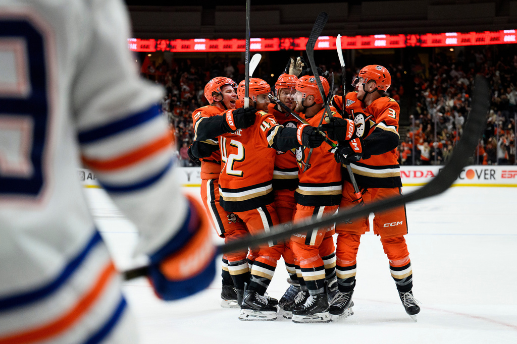Anaheim Ducks players celebrate a goal by left wing Jeffrey Viel during the third period of Game 4 in the first round of an NHL hockey Stanley Cup playoff series against the Edmonton Oilers, Sunday, April 26, 2026, in Anaheim, Calif. (AP Photo/Kyusung Gong)