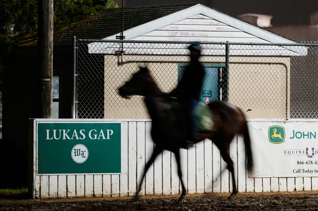 A horse comes off the track through the Lukas Gap gate, named in honor of deceased Hall of Fame trainer D. Wayne Lukas, Wednesday, April 29, 2026, at Churchill Downs in Louisville, Ky. (AP Photo/Charlie Riedel)