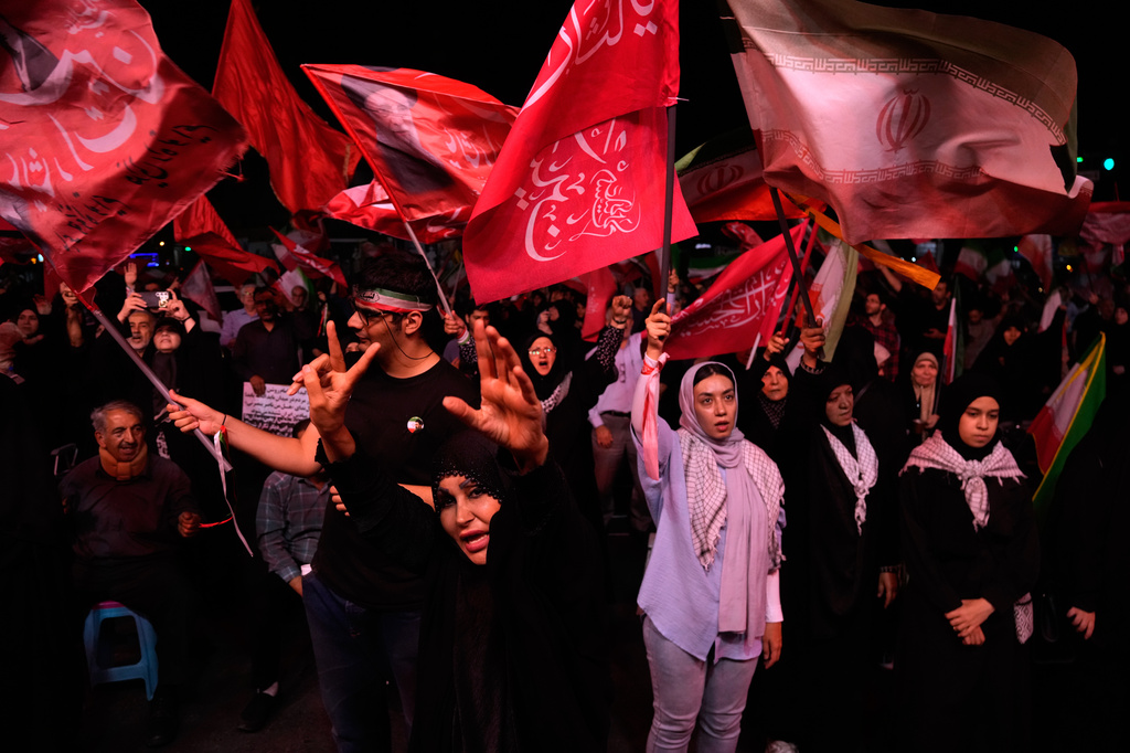 Iranian pro-government demonstrators chant slogans in a gathering at a square in Tehran, Iran, Tuesday, July 28, 2026. (AP Photo/Vahid Salemi)