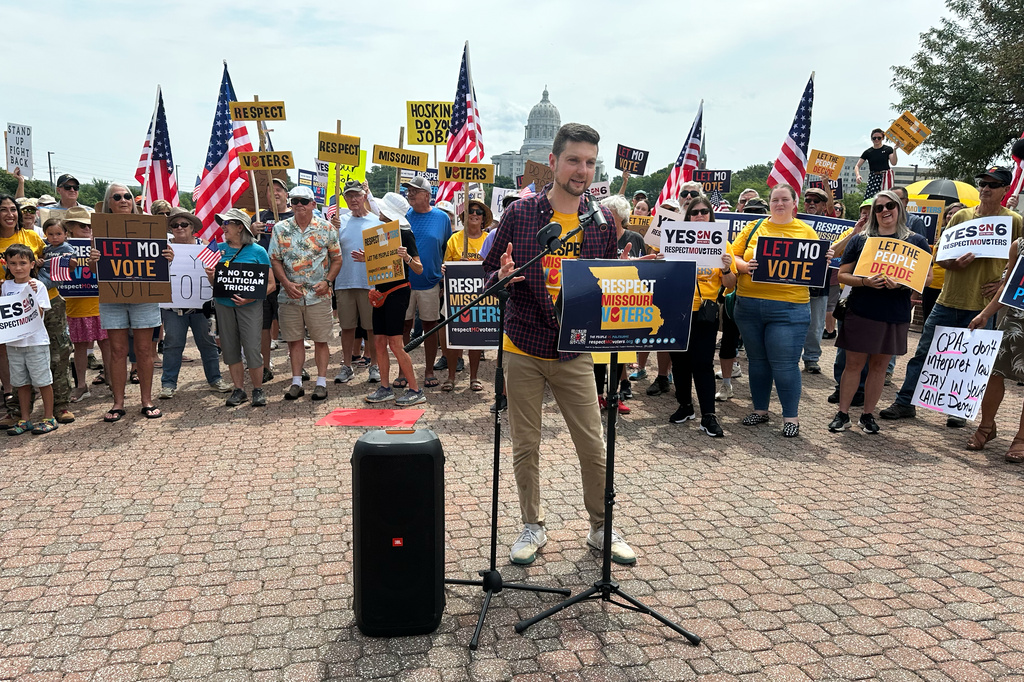 Benjamin Singer, co-founder of Respect Missouri Voters, leads a rally in support of a proposed constitutional amendment near the state Capitol in Jefferson City, Mo., Friday, Aug. 7, 2026. (AP Photo/David A. Lieb)