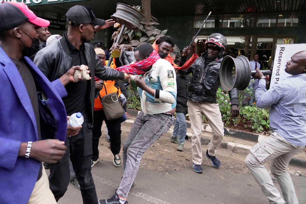 FILE - A suspected pro-government supporter is attacked by protesters during a demonstration over the death of blogger Albert Ojwang in police custody, in downtown Nairobi, Kenya, June 17, 2025. (AP Photo/Brian Inganga, File)