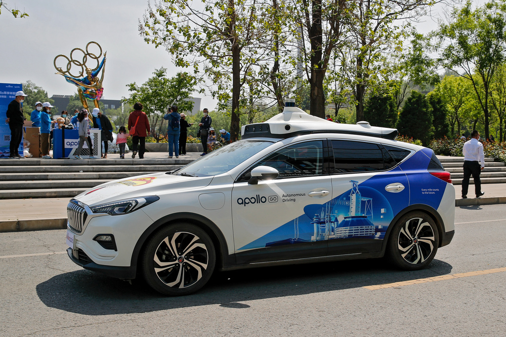 FILE - A Baidu Apollo Robotaxi passes its customer service counter setup at the Shougang Park in Beijing, on May 2, 2021. (AP Photo/Andy Wong, File)