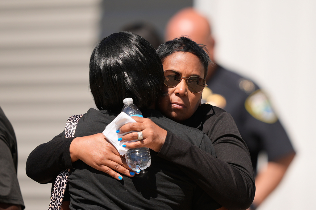 Council woman Tabatha Taylor, right, hugs an unknown person outside the scene of a mass shooting in Shreveport, La., Sunday, April 19, 2026. (AP Photo/Gerald Herbert)