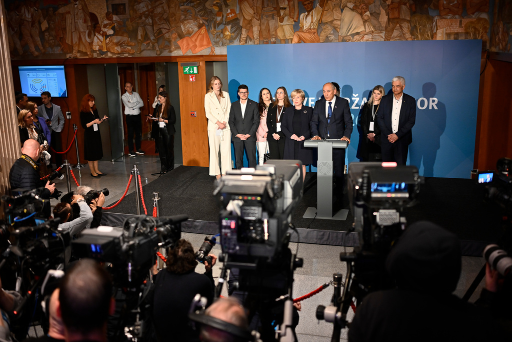 Former Prime Minister of Slovenia Janez Jansa, middle, addresses the media at the parlament in Ljubljana, Slovenia, on Sunday, March 22, 2026. (AP Photo/Denes Erdos)