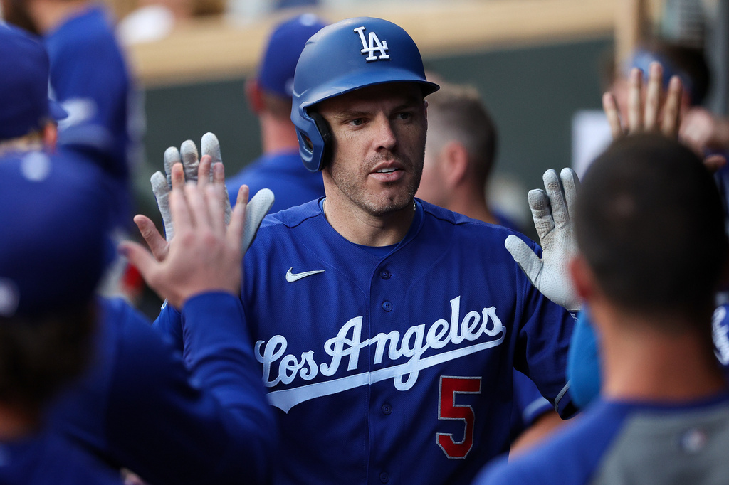 Los Angeles Dodgers' Freddie Freeman celebrates his solo home run with teammates during the sixth inning of a baseball game, Monday, June 22, 2026, in Minneapolis. (AP Photo/Matt Krohn)