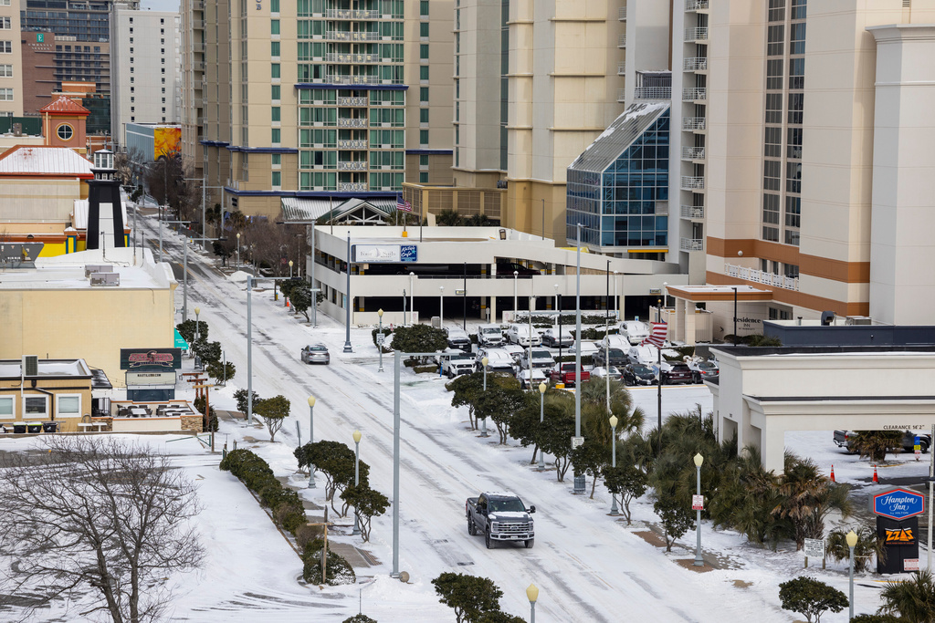 Snow covers Atlantic Ave at the Virginia Beach ocean front during below freezing temperatures in Virginia Beach, Va., on Sunday, Feb, 1, 2026. (Peter Casey/The Virginian-Pilot via AP)