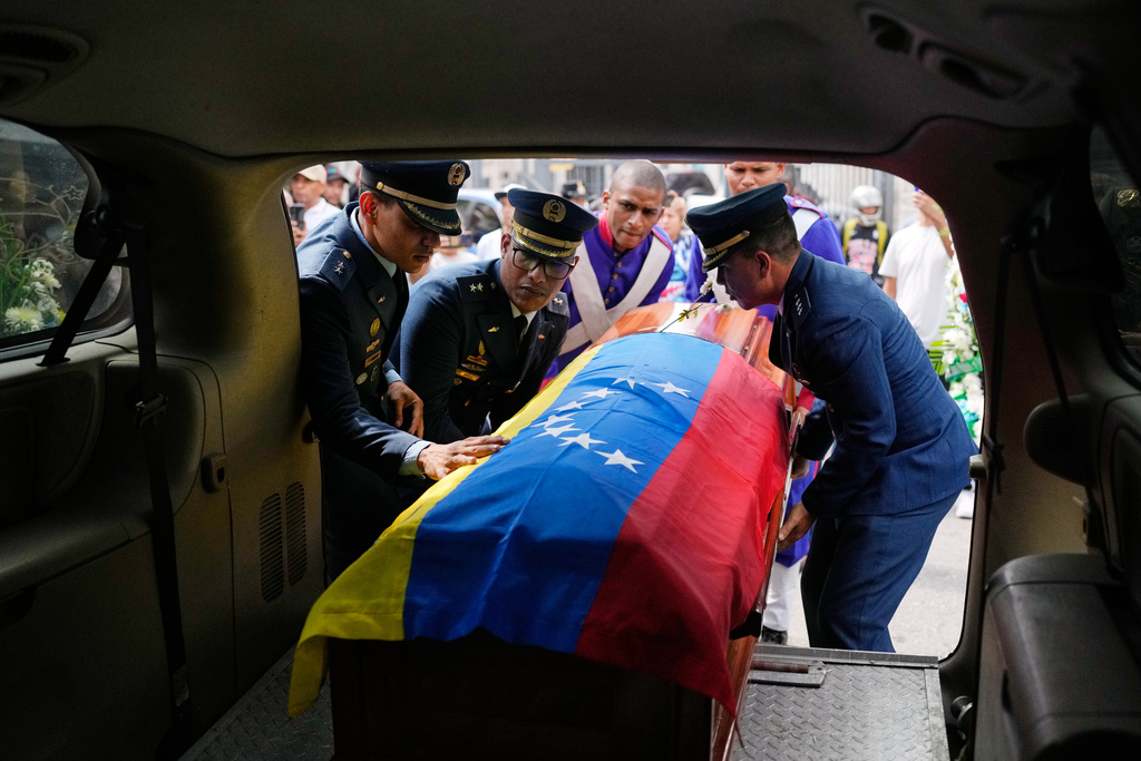 Members of the military place the coffin of Venezuelan soldier Cesar Garcia, killed in a U.S. raid that captured Venezuelan President Nicolas Maduro, into a hearse after his wake in Caracas, Venezuela, Wednesday, Jan. 7, 2026. (AP Photo/Matias Delacroix)