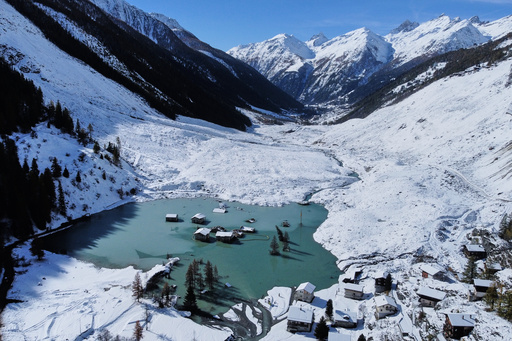An aerial view shows the partly flooded village of Blatten after recent snowfalls, five months after a landslide destroyed the village, Blatten, Switzerland, on Tuesday, Oct. 28, 2025. (AP Photo/Michael Probst) An aerial view shows the partly flooded village of Blatten after recent snowfalls, five months after a landslide destroyed the village, Blatten, Switzerland, on Tuesday, Oct. 28, 2025. (AP Photo/Michael Probst)