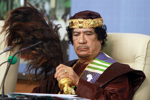 FILE - Libyan leader Moammar Gadhafi fans his face during the Forum of Kings, Princes, Sultans, Sheikhs and Mayors of Africa in Tripoli on Sept. 8 2010. (AP Photo/Abdel Magid Al Fergany, File) FILE - Libyan leader Moammar Gadhafi fans his face during the Forum of Kings, Princes, Sultans, Sheikhs and Mayors of Africa in Tripoli on Sept. 8 2010. (AP Photo/Abdel Magid Al Fergany, File)