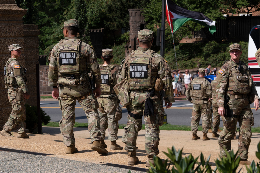 Members of the National Guard form a security line as protesters hold a rally near a ceremony attended by Defense Secretary Pete Hegseth, Thursday, July 2, 2026, in Washington. (AP Photo/Manuel Balce Ceneta)