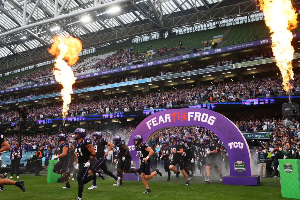 TCU players run onto the field before an NCAA college football game against North Carolina in Dublin, Ireland, Saturday, Aug. 29, 2026. (AP Photo/Peter Morrison)