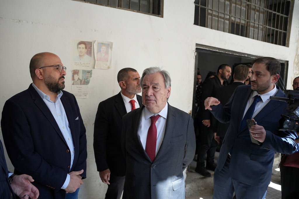 United Nations Secretary General Antonio Guterres, centre, stands next of a former prisoner Diab Seriyeh, left, during a guided visit to the infamous Saydnaya military prison north of Damascus, Syria, Saturday, July 25, 2026. (AP Photo/Omar Albam)