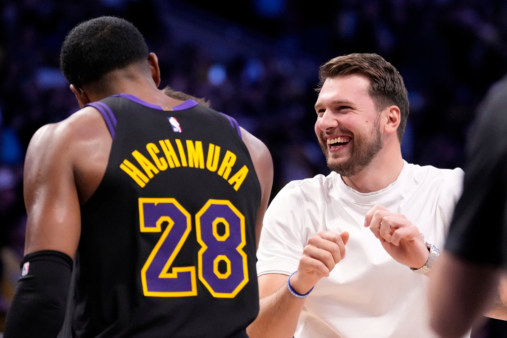 Los Angeles Lakers' Luka Doncic, right, celebrates with forward Rui Hachimura after the Lakers defeated the Houston Rockets in Game 2 of a first-round NBA playoffs basketball series Tuesday, April 21, 2026, in Los Angeles. (AP Photo/Mark J. Terrill)