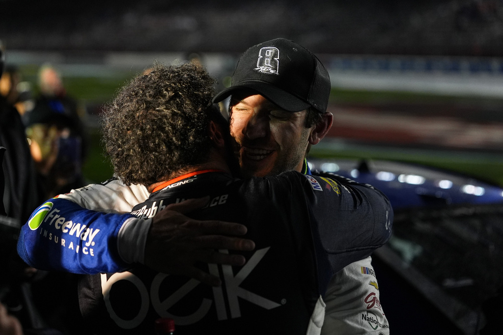 Daniel Suarez, right, is embraced by Bubba Wallace after winning a NASCAR Cup Series auto race, Sunday, May 24, 2026, in Charlotte, N.C. (AP Photo/Matt Kelley)
