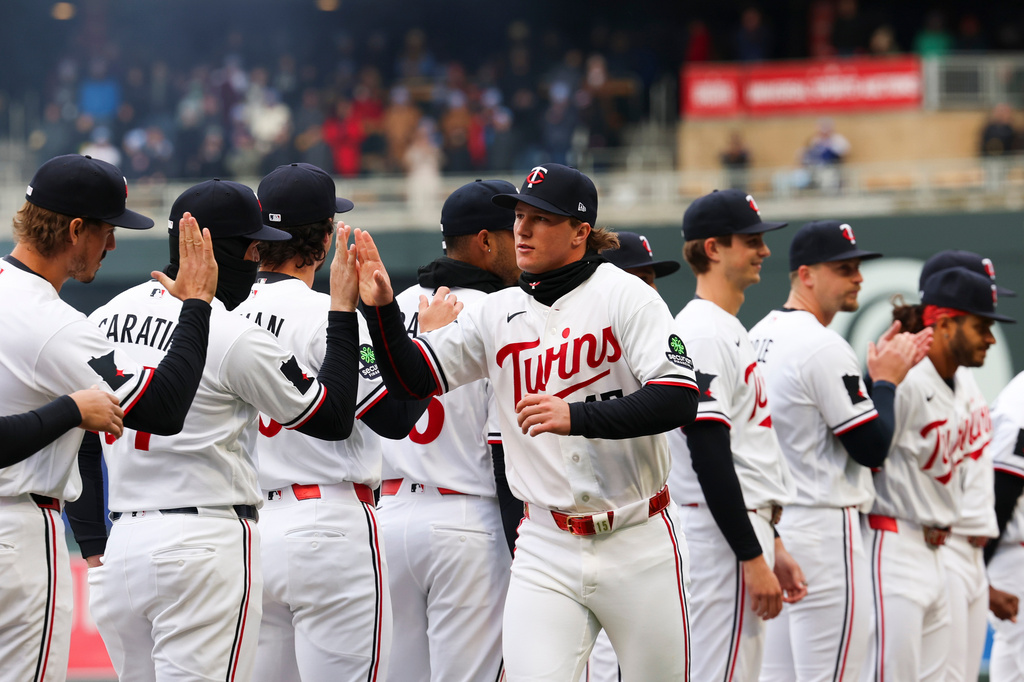 Minnesota Twins' Luke Keaschall, center, is announced in his team's starting lineup before a baseball game against the Tampa Bay Rays, Friday, April 3, 2026, in Minneapolis. (AP Photo/Ellen Schmidt)