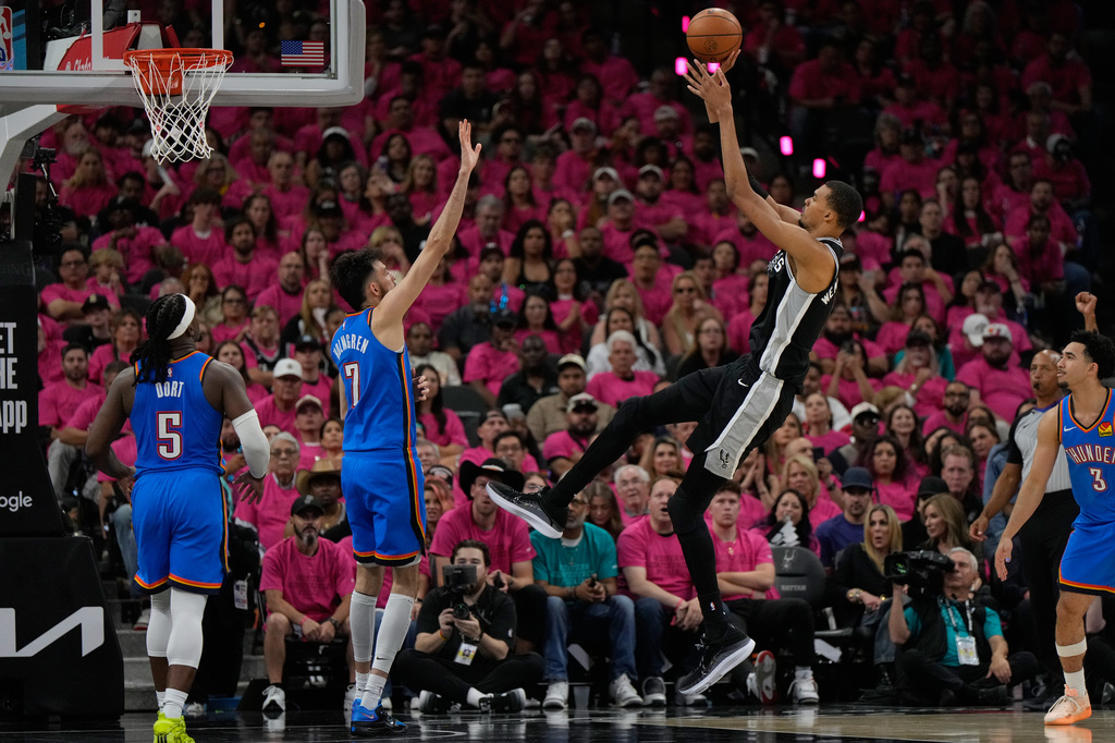San Antonio Spurs forward Victor Wembanyama shoots over Oklahoma City Thunder center Chet Holmgren (7) during the second half of Game 3 in the Western Conference finals NBA basketball playoffs series Friday, May 22, 2026, in San Antonio. (AP Photo/Ashley Landis)