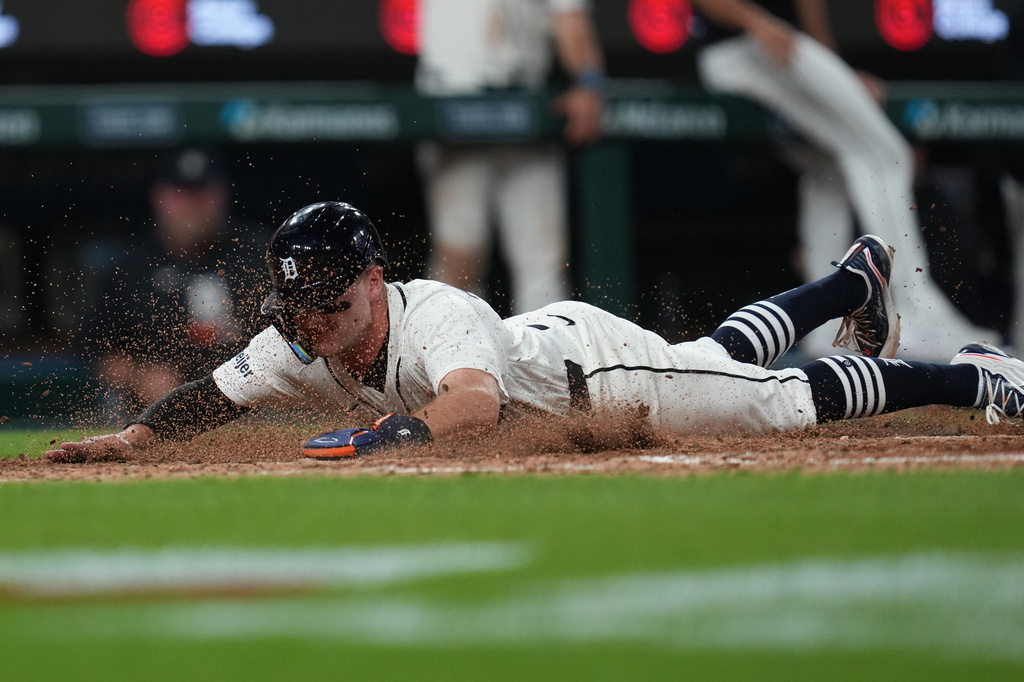 Detroit Tigers' Kevin McGonigle slides safely into home plate against the Kansas City Royals during the eighth inning of a baseball game Tuesday, April 14, 2026, in Detroit. (AP Photo/Paul Sancya)