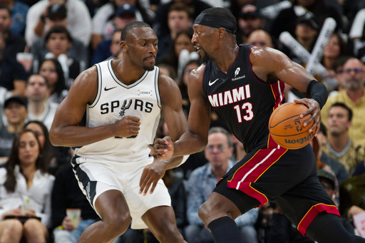 Miami Heat forward Bam Adebayo (13) drives against San Antonio Spurs center Bismack Biyombo, left, during the second half of an NBA basketball game, Thursday, Oct. 30, 2025, in San Antonio. (AP Photo/Darren Abate) Miami Heat forward Bam Adebayo (13) drives against San Antonio Spurs center Bismack Biyombo, left, during the second half of an NBA basketball game, Thursday, Oct. 30, 2025, in San Antonio. (AP Photo/Darren Abate)