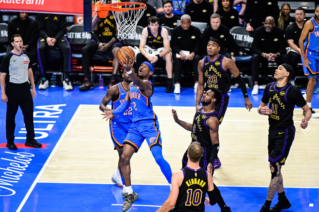 Oklahoma City Thunder guard Shai Gilgeous-Alexander (2) shoots against Los Angeles Lakers guard Bronny James (9) during the second half of an NBA basketball game Thursday, April 2, 2026, in Oklahoma City. (AP Photo/Gerald Leong)