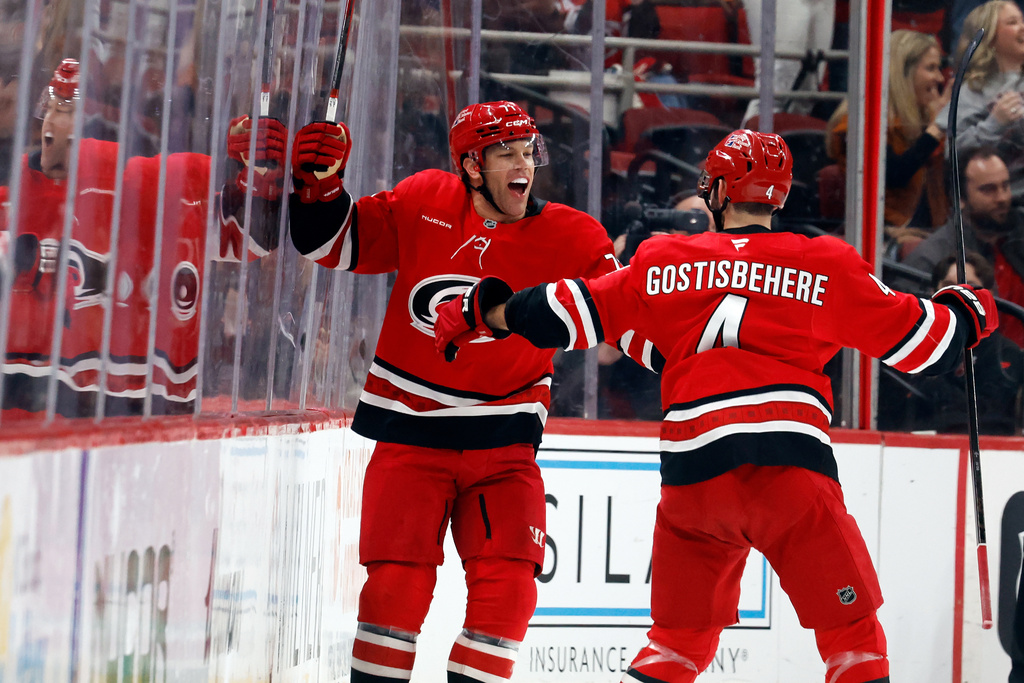 Carolina Hurricanes' Taylor Hall, left, celebrates his goal with teammate Shayne Gostisbehere (4) during the first period of an NHL hockey game against the Detroit Red Wings in Raleigh, N.C., Saturday, Feb. 28, 2026. (AP Photo/Karl DeBlaker)