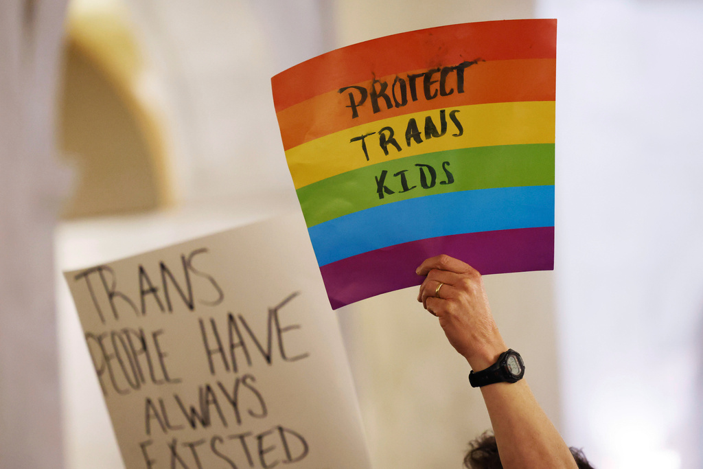 FILE - Protestors hold signs during a rally at the state capitol in Charleston, W.Va., on March 9, 2023. (AP Photo/Chris Jackson, file)