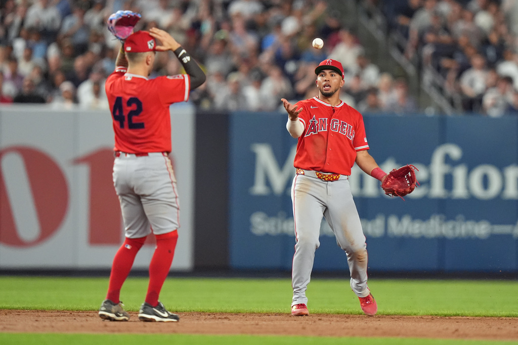 Los Angeles Angels' Zach Neto, left, and Oswald Peraza, right, react after a ball dropped between them allowing a single for New York Yankees' Jazz Chisholm Jr. during the ninth inning of a baseball game Wednesday, April 15, 2026, in New York. (AP Photo/Frank Franklin II)