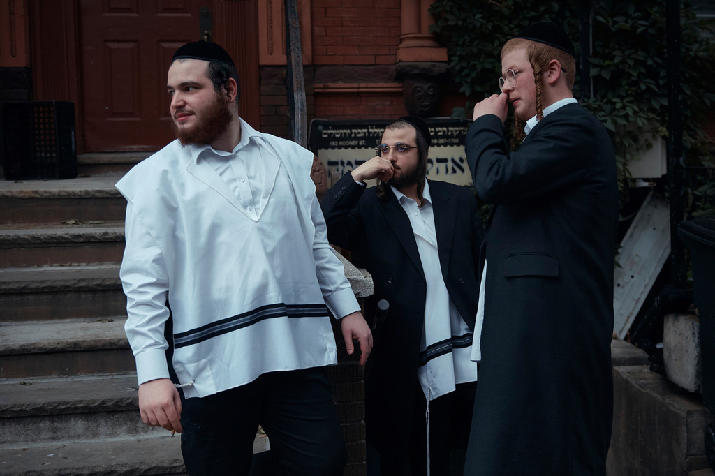 FILE - Hasidic Jewish men chat on June 16, 2025, in the Brooklyn borough of New York. (AP Photo/Andres Kudacki, File)