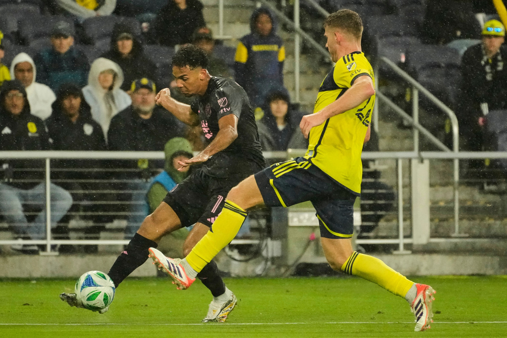 Inter Miami defender Ian Fray, left, kicks the ball past Nashville SC defender Josh Bauer, right, during the first half of Game 2 in the first round of MLS soccer Eastern Conference playoff Saturday, Nov. 1, 2025, in Nashville, Tenn. (AP Photo/George Walker IV)