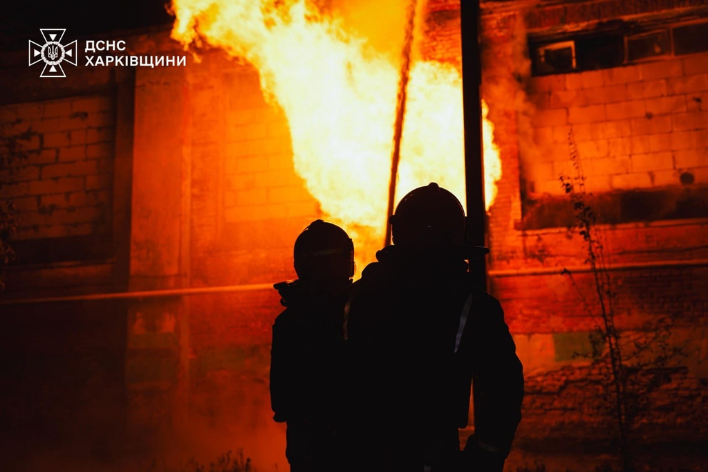 In this photo provided by the Ukrainian Emergency Services on Tuesday, Oct. 14, 2025, rescue workers put out a fire of a hospital damaged by a Russian strike in Kharkiv, Ukraine. (Ukrainian Emergency Service via AP)