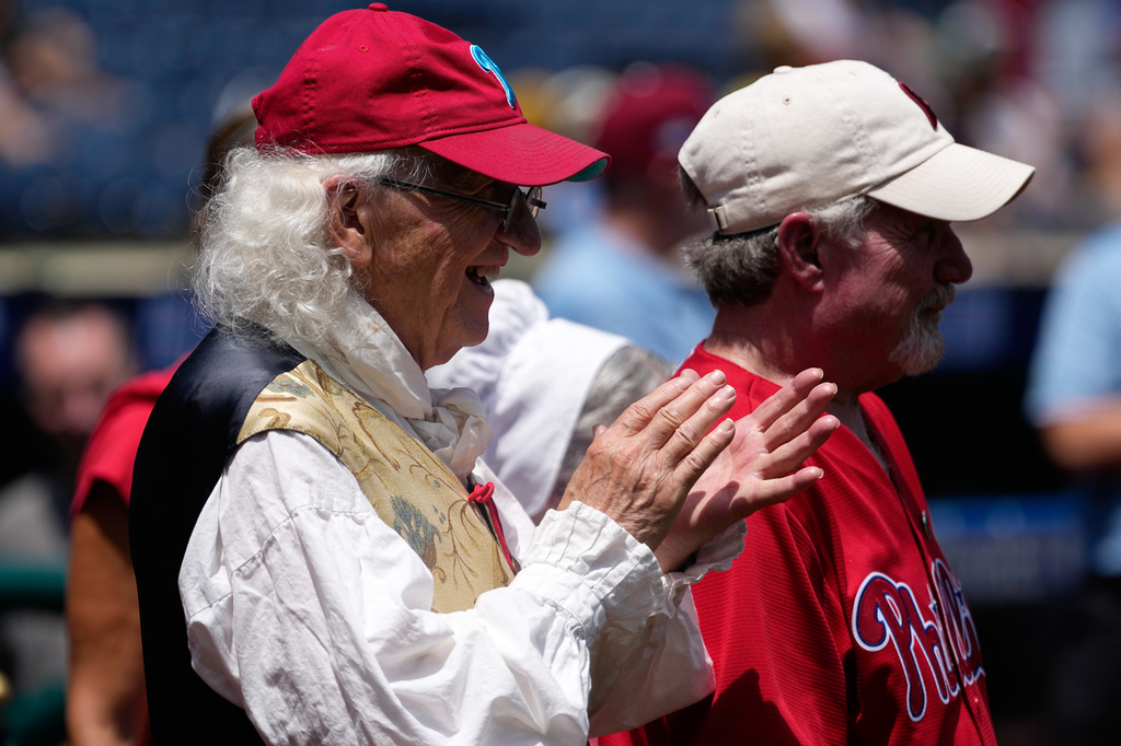 Bill Robling as Benjamin Franklin, left, cheers before a baseball game between the Philadelphia Phillies and the Pittsburgh Pirates Thursday, July 2, 2026, in Philadelphia. (AP Photo/Matt Slocum)