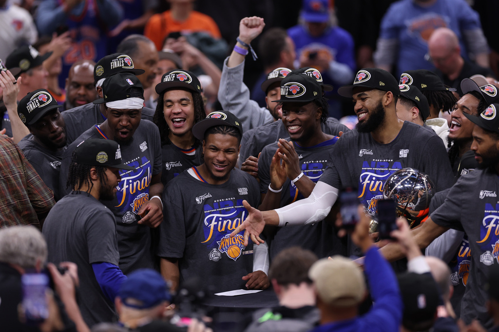 New York Knicks players celebrate with guard Jalen Brunson, left, after he was awarded with the MVP trophy after winning Game 4 in the Eastern Conference finals NBA basketball playoffs series against the Cleveland Cavaliers in Cleveland, Monday, May 25, 2026. (AP Photo/Tim Phillis)