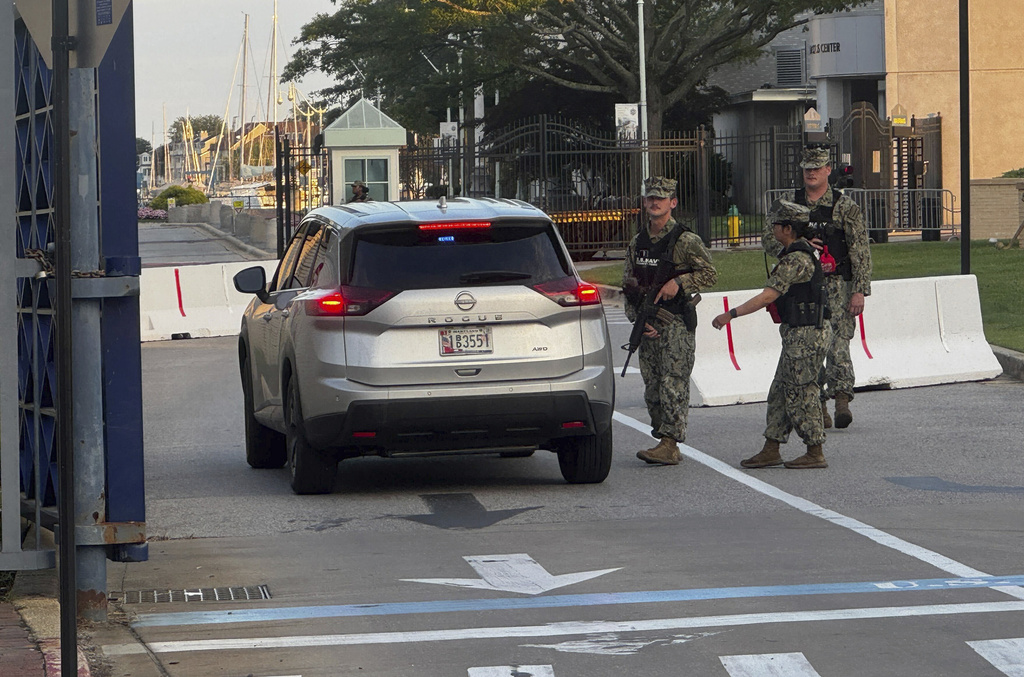 U.S. Navy Security Forces stand at the entrance to Gate 1 at the U.S. Naval Academy in Annapolis, Md., Thursday, Sept. 11, 2025. (Ben Rothstein/The Baltimore Sun via AP)