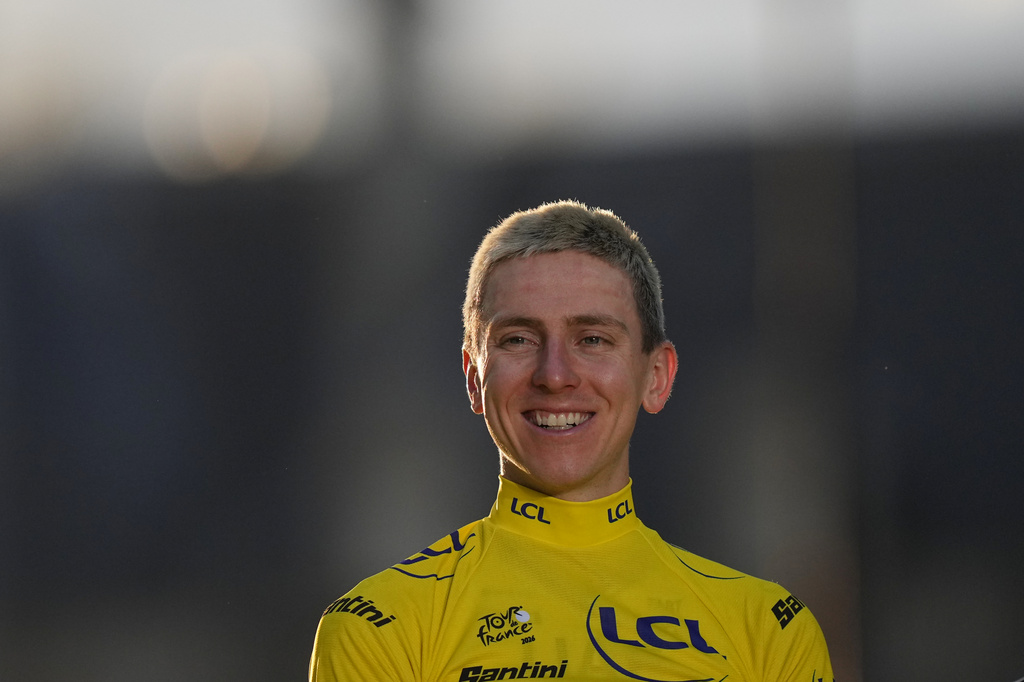 Slovenia's Tadej Pogacar, wearing the overall leader's yellow jersey, celebrates on the podium after the last stage of the Tour de France cycling race with start and finish in Paris, Sunday, July 26, 2026. (AP Photo/Thibault Camus)