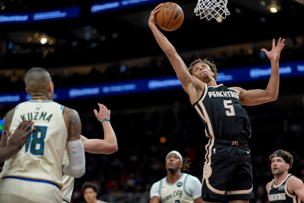Atlanta Hawks guard Dyson Daniels (5) shoots against the Milwaukee Bucks during the first half of an NBA basketball game, Monday, Jan. 19, 2026, in Atlanta. (AP Photo/Mike Stewart)